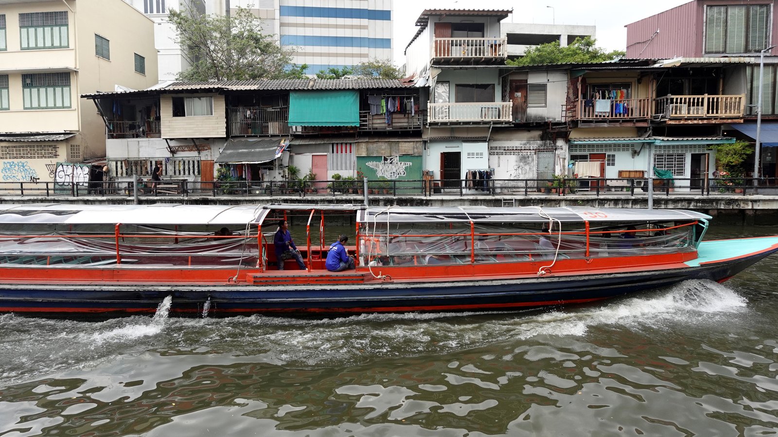 Bateau de transport public naviguant sur le khlong Saen Saep à Bangkok, une voie historique au cœur de la capitale thaïlandaise.